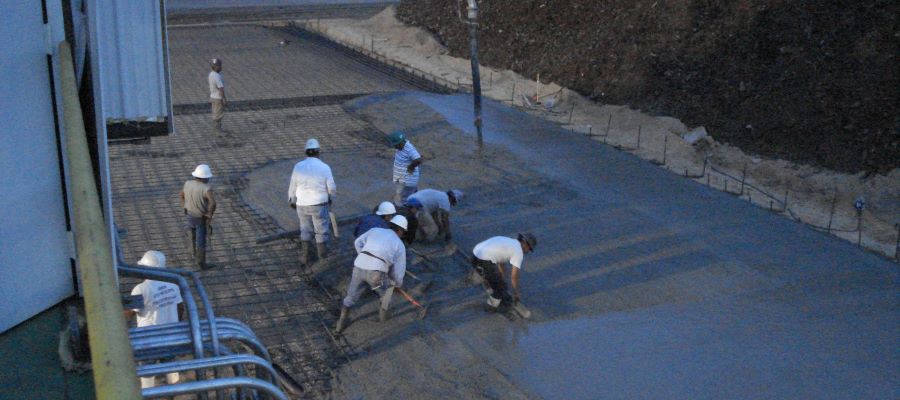 the concrete crew placing concrete paving at night
